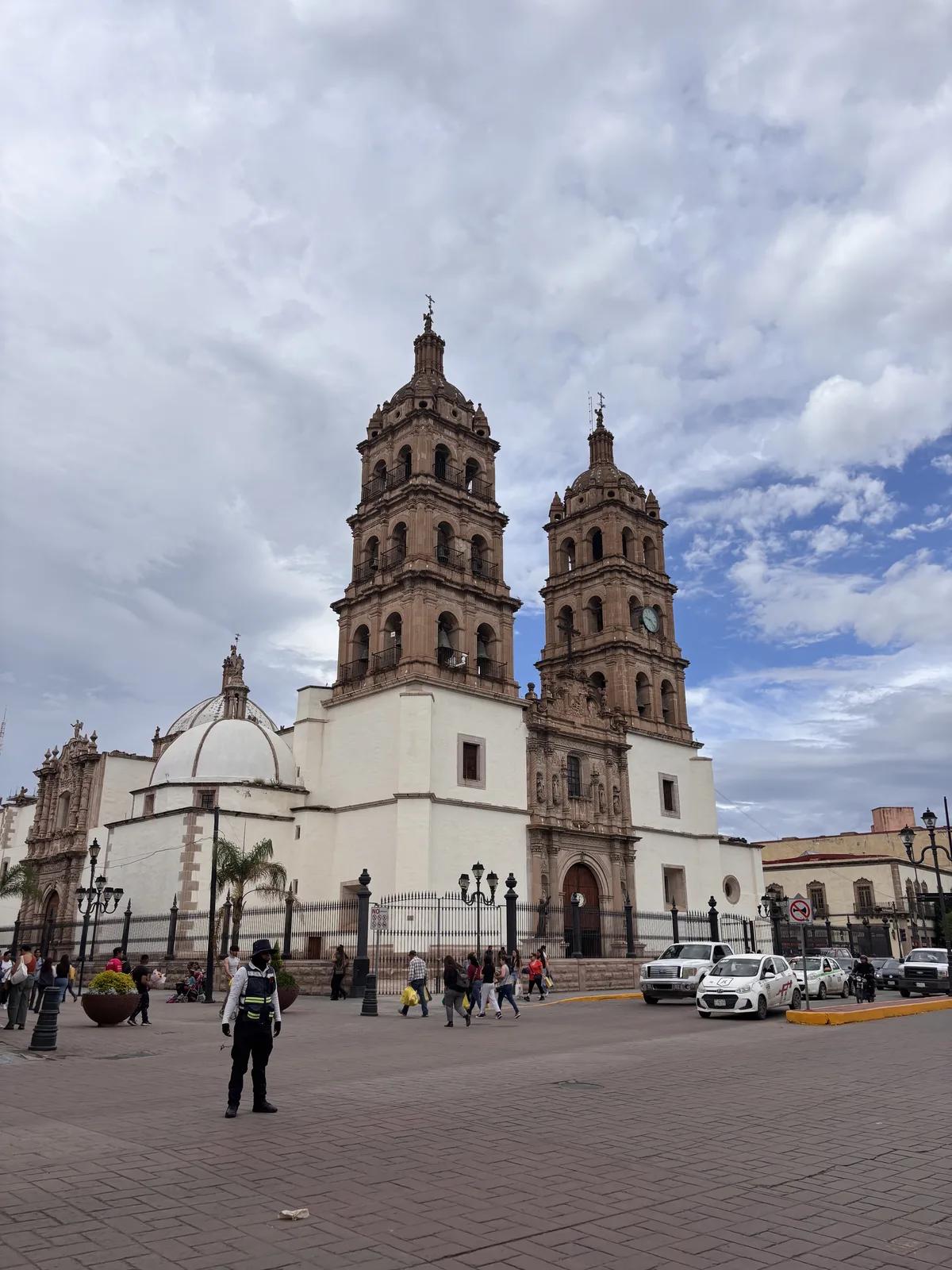 A cathedral and busy public plaza in Mexico